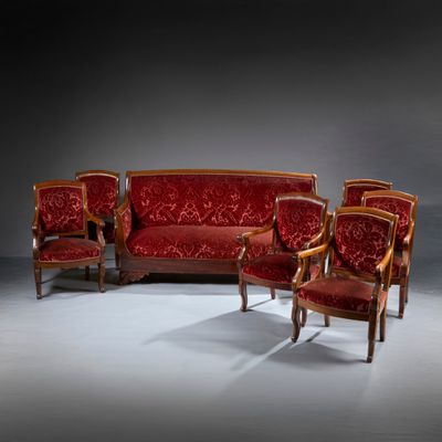 three chairs and a couch in a room with a dark background