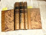 three old books sitting on top of a table next to each other