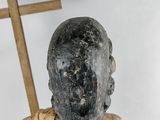 statue of a person with a cross on a white background