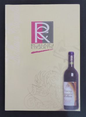 a bottle of wine sitting on a table next to a menu