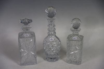 three clear glass bottles sitting next to each other on a white surface