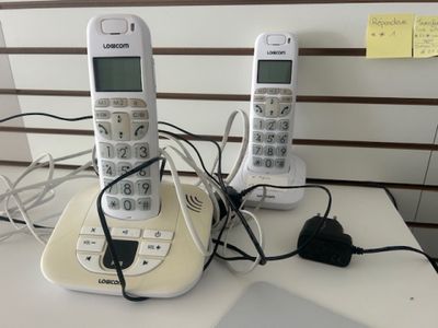 two phones that are sitting on a table