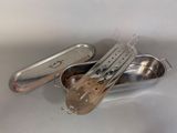 a small metal container with a spoon and tongs inside of it