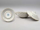 a set of three porcelain dishes and a saucer