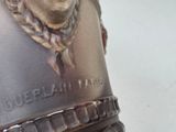 a bronze statue of a man with a chain around his neck