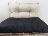 a black and white chair with a pillow on top of it