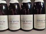 six bottles of wine are lined up on a table