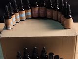 many bottles of essential oils in a box on a table