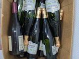 many bottles of wine in a box on the floor