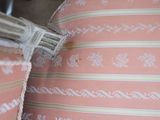a close up of a pink pillow with a decorative design on it