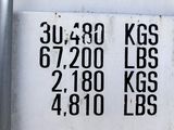 a white sign with black writing on it that says 3, 480 kgs and 6, 700 lbss