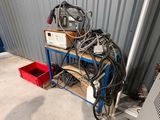 a metal shelf with a bunch of wires on top of it