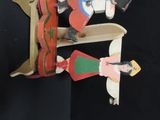 a wooden toy of a man and a woman on a skateboard
