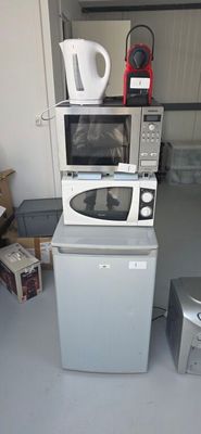 a microwave and a microwave oven sitting on top of each other