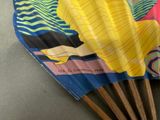 a yellow and blue umbrella with a woman on it