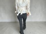 an image of a woman in a white shirt and jeans