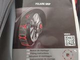 the back of a bag with a pair of snow chains attached to it