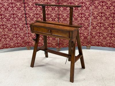 a small wooden desk with a chair on top of it