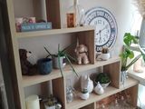 a shelf that has a clock on top of it