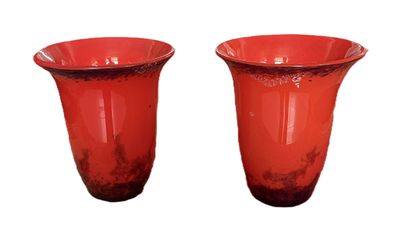 two red vases sitting next to each other on a white surface