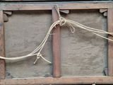 a picture of a wooden frame with a rope hanging from it
