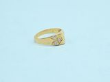 a close up of a gold ring with a diamond on it