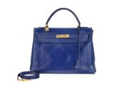 a blue leather handbag on a white background