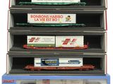 four model train cars are stacked on top of each other