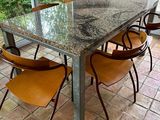 a table with four chairs around it in a room