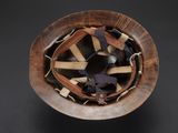 a wooden bowl with a baseball glove inside of it