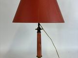 an image of a table lamp with a red shade on it