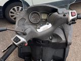 a motor scooter that is parked in a parking lot
