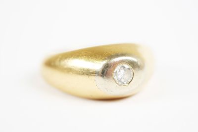 a close up of a gold ring with a diamond on it