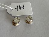 a pair of diamond earrings with a price tag on a white background