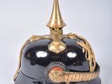 a black helmet with a gold decoration on it