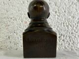 a small statue of a man with a hat on it