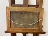 a picture of an old wooden easel with a painting on it