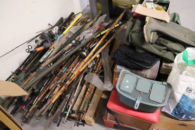 a pile of fishing rods and other fishing equipment on the floor
