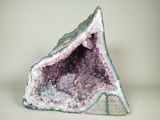 a close up of a piece of rock with purple crystals