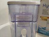 a water purifier sitting on a counter next to a box of water