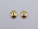 a pair of gold plated beads