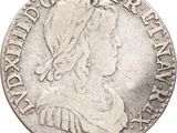 a silver coin with a woman ' s head on it