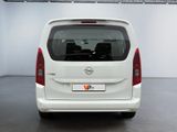 the back end of a white van parked in a garage