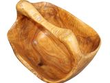 a wooden bowl with a wooden spoon in it on a white background