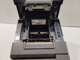 the printer is sitting on top of the machine on the table