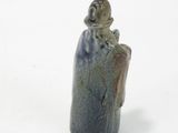 a figurine of a man sitting on top of a rock