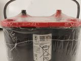 a plastic container with a red lid on a table