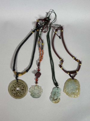 three necklaces with different colored beads and charms hanging from them