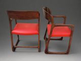 pair of mid century chairs with red leather upholstered seats