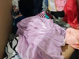 a cardboard box filled with clothes and a bag